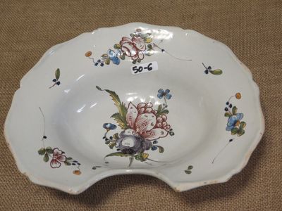 a plate with a flower design on it on a table