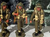 four figurines of soldiers standing next to each other