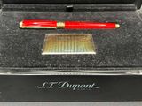 an image of a red pen sitting inside of a black box