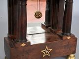 a small wooden clock with a star on it