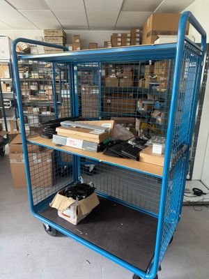 a large blue cage with boxes on top of it