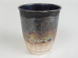 a close up of a cup on a white surface