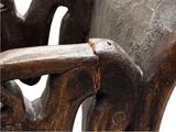 a close up of a wooden bench with a rusted seat