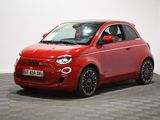 a red smart car is parked in a room with checkered floor