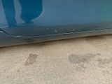 a blue car that is parked on the side of the road