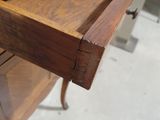 a drawer that is open on the side of a table