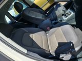 the interior of a car with two seats and a steering wheel