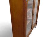 a wooden cabinet with a glass door on the front