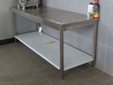 a stainless steel table in a kitchen with a toaster on it