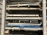 a large stack of metal and wood pallets in a warehouse