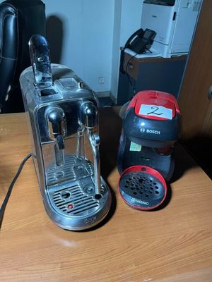 a coffee machine and a coffee cup on a table