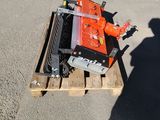 a man standing next to a pallet with a small engine on it
