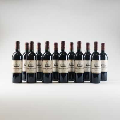 six bottles of wine lined up in a row on a white surface
