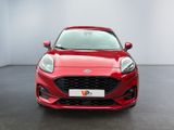 the front of a red ford fiesta parked in a showroom