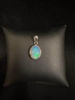 a white oplite pendant sitting on top of a black pillow