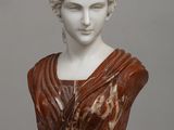marble bust of a woman wearing a red dress