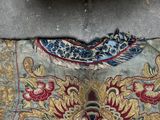 a piece of cloth with a design on it on the ground