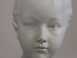 a close up of a statue of a child ' s head