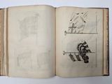 an open book with drawings on it on a table