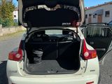 a white car with its trunk open in a parking lot