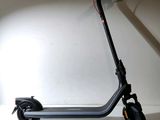a scooter that is sitting on a white surface