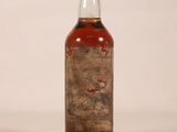 a bottle of whiskey sitting on a white surface