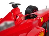 a close up of a red race car with a shell on the front