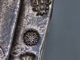 a close up of a metal object with a cross on it