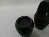 two black vases sitting next to each other on a table