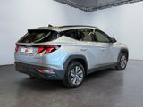 the rear end of a silver toyota rav parked inside of a building