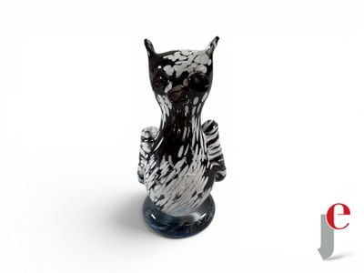 a black and white cat figurine sitting on top of a table