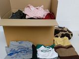 a cardboard box filled with clothes and other items
