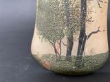 a vase that has a picture of a tree on it