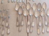 many spoons and spoon spoons hanging on the wall