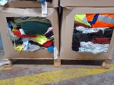 two cardboard boxes with clothes in them on a pallet