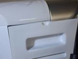 an image of a white machine with a power cord plugged into it