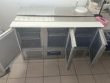a picture of a kitchen with a refrigerator and a counter top