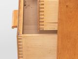 a wooden drawer with two drawers on top of it