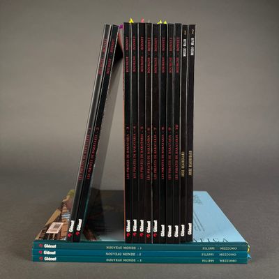 several books are stacked on top of each other on a table