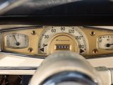 a close up of a car dashboard with a speedometer and gauges