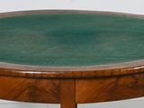a wooden table with a green top on a white floor