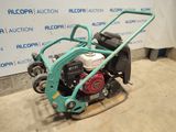 an image of a small lawn mower in a garage