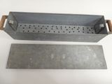 two metal trays with holes on them sitting on a white surface