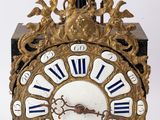 a gold clock with blue and white decorations on it