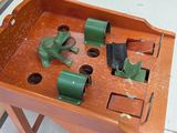 a small wooden table with a green frog on it