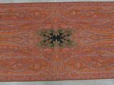 an orange and blue rug with a decorative design on it