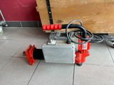 a red and black fire hydrant on the floor