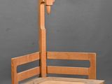 a wooden bench with a lamp on top of it