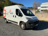 a white van that is parked on the side of the road