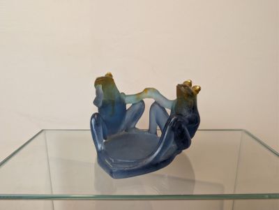 a glass table with a blue and gold figurine on top of it
